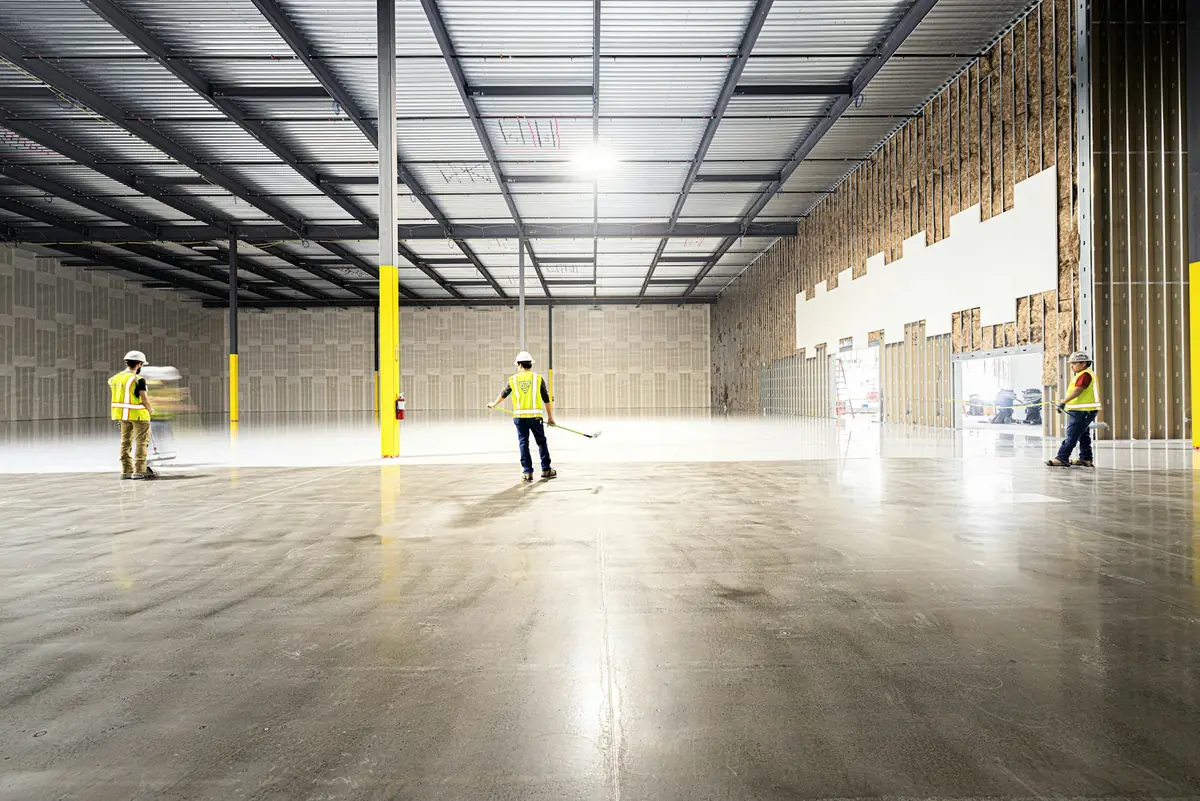 Team inspecting an epoxy warehouse floor